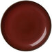 A white porcelain round coupe plate with a crimson center and brown rim.