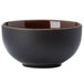A white porcelain bowl with a black exterior and brown rim.
