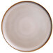 A white porcelain pizza plate with a brown rim.