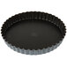 A black Matfer Bourgeat fluted non-stick tart pan with a removable bottom.