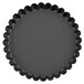 A black round Matfer Bourgeat fluted tart pan with a scalloped edge.
