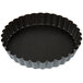 A black Matfer Bourgeat fluted tart pan with a removable bottom.
