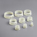 A group of white plastic rings with black text.