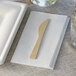 A Bamboo by EcoChoice compostable bamboo knife on a napkin.