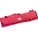 A pink Mercer Culinary knife roll with straps.