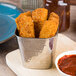 An American Metalcraft stainless steel fry cup filled with fried chicken strips.