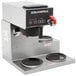 A Bloomfield automatic coffee brewer with three black warming plates on a counter.