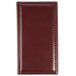 A burgundy leather Menu Solutions guest check presenter on a table.