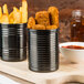 American Metalcraft black stainless steel soup cans filled with fries and red sauce on a table.