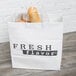 A white rigid plastic shopper bag with "Fresh Flavor" printing filled with baguettes.