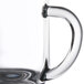 A close up of a Libbey glass coffee mug with a handle.