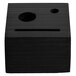 A black square wood block with a hole in the face.