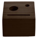 A walnut wood block check presenter with a face cut out.