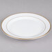 A CAC porcelain plate with a gold rim.