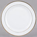 A CAC Golden Royal bright white porcelain plate with a gold rim.
