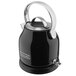 A black and silver KitchenAid electric kettle on a counter.
