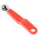 A Prince Castle tomato corer with a red plastic handle.