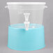 A clear plastic beverage dispenser with a blue base and white spout.