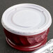 A translucent plastic container with a Dinex translucent plastic lid.