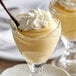 Two dessert cups of Cafe Classics vanilla pudding with whipped cream on top.