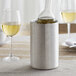 An American Metalcraft stainless steel wine cooler with a bottle in it on a table.