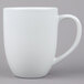 A Tuxton white porcelain mug with a handle.