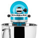 A blue KitchenAid tilt-head mixer with a blue lid.