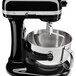 A KitchenAid tilt-head stand mixer with a black and silver flex edge beater.