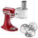 A white KitchenAid stand mixer with a circular attachment on the front.