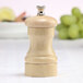 A Chef Specialties maple wood pepper mill with a lid.