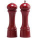 Two red Chef Specialties pepper mills with a silver top and black handle.