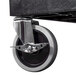 A black and silver Luxor utility cart wheel.