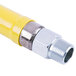 A close-up of a yellow T&S Safe-T-Link gas appliance connector hose.