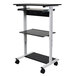 A black and white Luxor standing workstation with wheels.