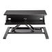 A black Luxor adjustable standing desk with a small shelf on top.