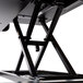 A black Luxor adjustable two-tier desktop desk on a black metal stand.