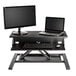 A black Luxor adjustable two-tier desktop desk with a computer and monitor on it.