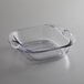 A clear glass square pan with handles.