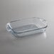 An Anchor Hocking clear glass baking dish on a white surface.