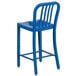 A blue metal outdoor restaurant bar stool with a backrest.