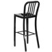 A Flash Furniture black metal bar stool with backrest.