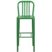 A green metal outdoor bar stool with a vertical slat back.