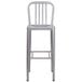 A silver metal bar stool with a slat back.