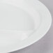 A close up of a white Cambro polycarbonate narrow rim plate with three compartments.