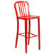 A Flash Furniture red metal bar stool with a vertical slat back.