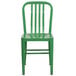 A green metal chair with a white background.