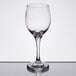 A close-up of a Libbey Perception wine glass on a reflective surface.