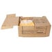 A cardboard box with six white and yellow packages of Gehl's Jalapeno Cheese Sauce inside.