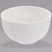 A Oneida Manhattan warm white porcelain bowl with a thin rim.