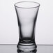 A Libbey clear glass shooter on a table.